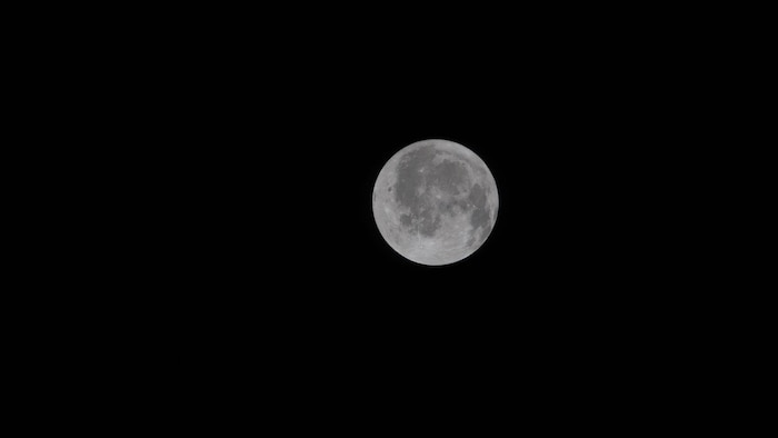 Sur cette photo de la Lune prise à bord de la capsule Orion, on aperçoit, à l'extrémité gauche, une première partie de la face cachée de la Lune.