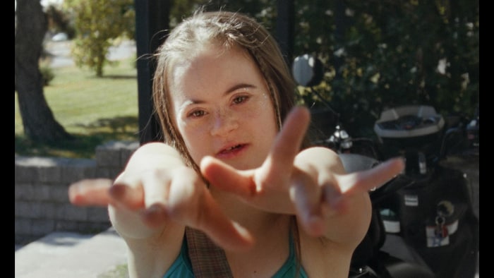 Une jeune femme a ses mains en avant. 
