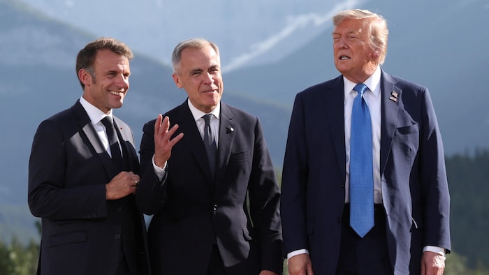 French President Emmanuel Macron, Canadian Prime Minister Mark Carney and US President Donald Trump participate in a photo session at the G7 top in Kananaskis, Alberta, Canada, June 16, 2025.