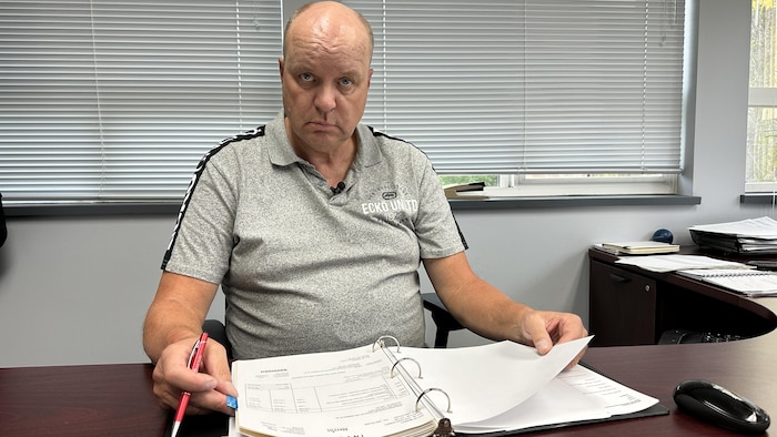 Michael Goetz in front of an open filing cabinet.