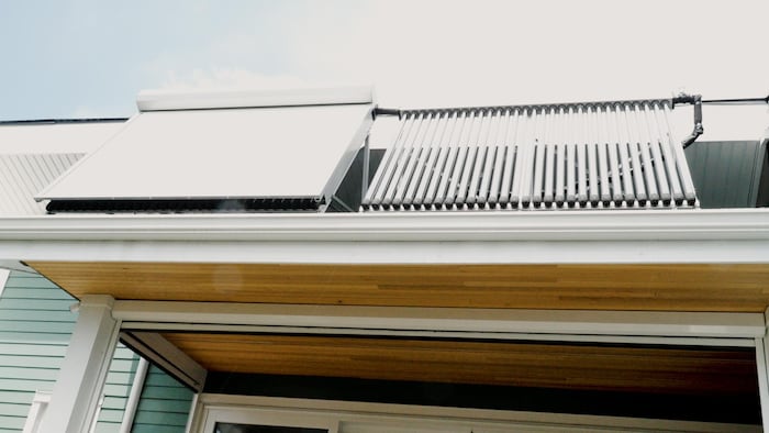 Une image d'une maison avec des panneaux solaires. 
