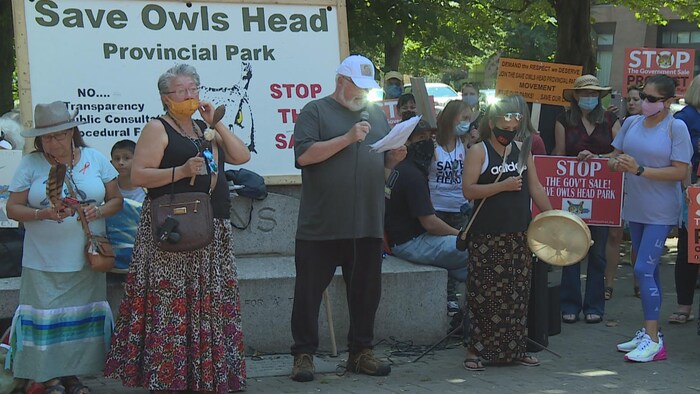 Un groupe de personnes rassemblées dans un espace public extérieur pour une manifestation.