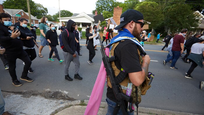 Un militant d'extrême droite armé se promène en périphérie d'une manifestation anti-racisme en Caroline du Nord, aux États-Unis.