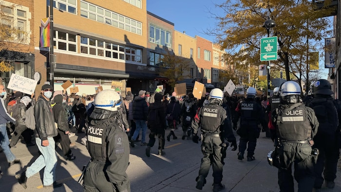 Des policiers escortent une manifestation.