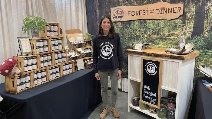 Une femme devant un comptoir de nourriture en pot.
