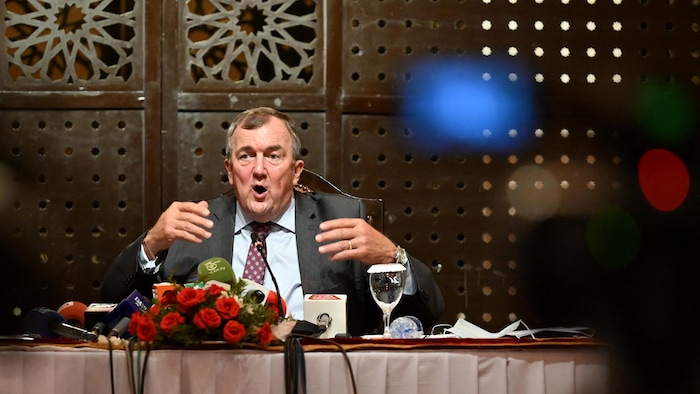 Mark Bristow speaks, seated at a table.
