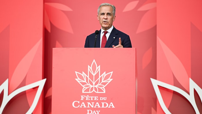 Mark Carney delivering a speech to a podium. canada day marked "canadian pride"