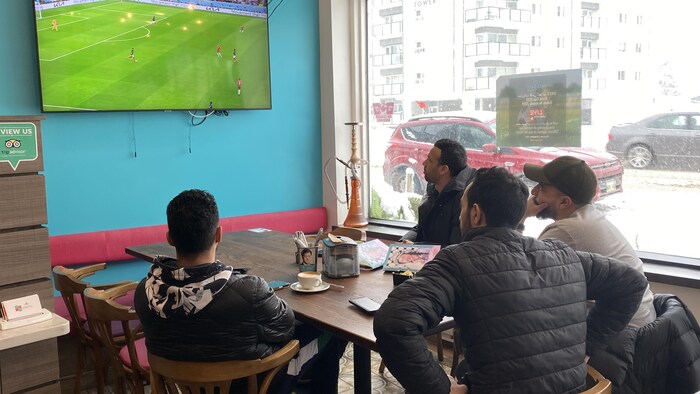 4 رجال يشاهدون المبارة بين فرنسا و’’أسود الأطلس‘‘ في مقهى ’’يايا‘‘ في وينيبيغ.