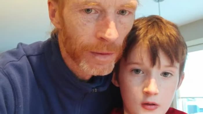Un homme se photographie en compagnie de son fils.