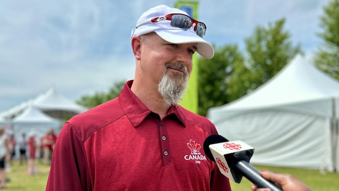 A spokesperson with a red polo shirt for Canada's party. canada day marked "canadian pride"