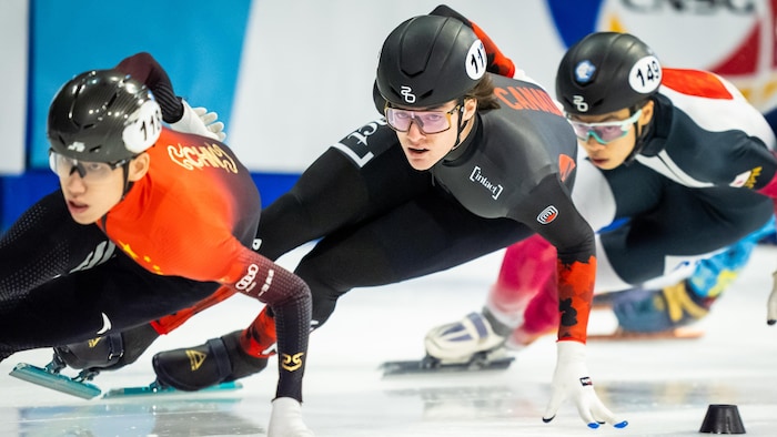 Des patineurs de vitesse dans un virage.