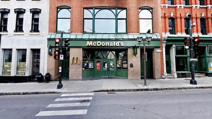 Un restaurant McDonald's aménagé dans un vieil immeuble. Les portes et l'enseigne sont vertes.