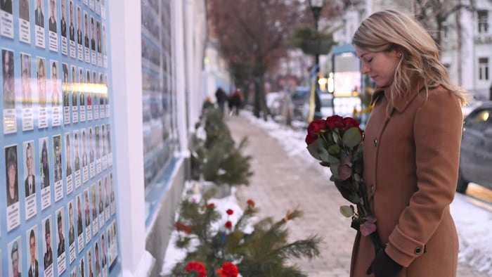 Canadian Foreign Minister Melanie Joly lays flowers at the Memorial Wall of Ukraine's fallen defenders during the Russo-Ukrainian War in Kiev.