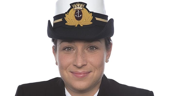 Mélanie Leblanc sourit à la caméra en uniforme.