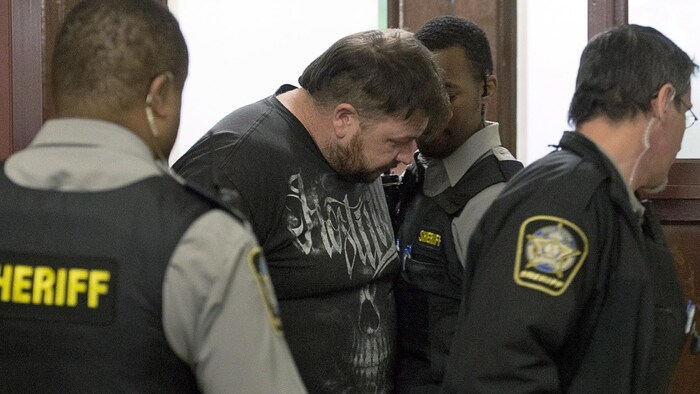 Christopher Fattore est escorté par des policiers dans un tribunal.