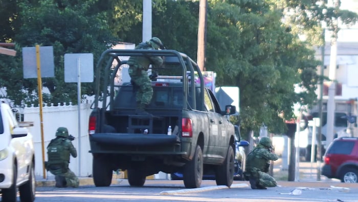 Soldiers stand in position following heavy fighting on the streets of Culiacan on Thursday.