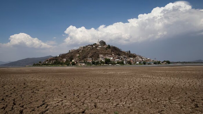 Cracked earth surrounds Janitzio Island in the partially dried-up Lake Patzcuaro on April 18, 2024. The lake has been reduced to about half its size due to drought, deforestation, sediment buildup and increased water demands from avocado and berry growers. 