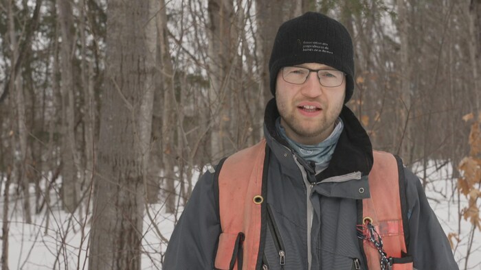 Michael Cliche devant une forêt. 