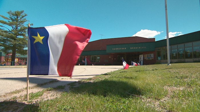 Acadian flags float in front of the Beausoleil crossroads acadia games, model french -speaking acadia games, model french -speaking new