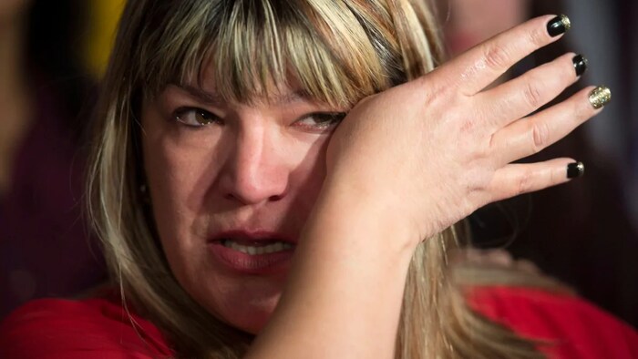 Bernadette Smith, from Winnipeg, wipes away tears as she talks about the government's decision to launch the first phase in a process that would see an inquiry into missing and murdered indigenous women announced sometime after next spring. Her sister, Claudette Osborne, has been missing since 2008.