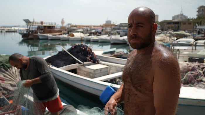 Mohammad Darwish on his fishing boat in the port of Tyr.