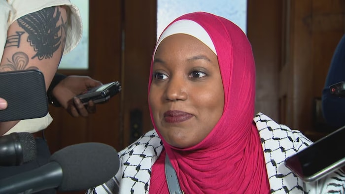 MPP Sarah Jama speaks to reporters in a scrum outside the legislative chamber on Thursday.