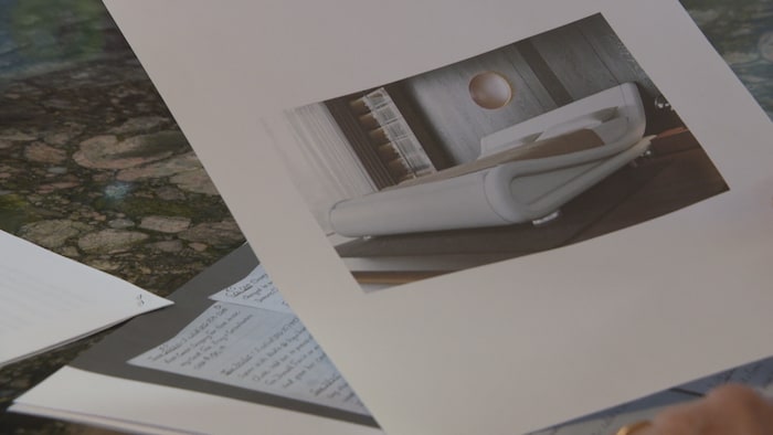 Des documents sur une table avec une photo d'un lit imprimé sur une page. 