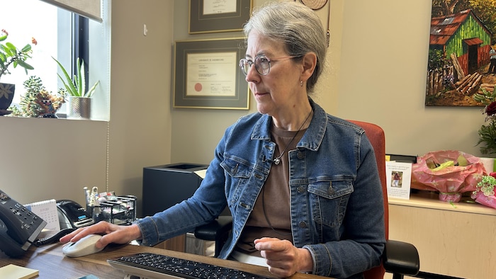 Nathalie St-Onge est assise à son bureau en train de travailler.