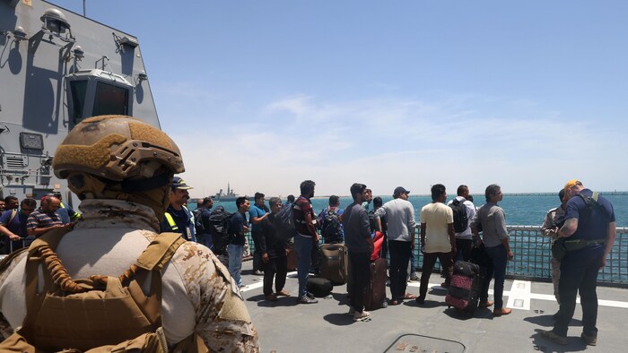 Des personnes évacuées à bord d'un bateau.