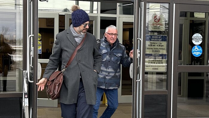 Deux personnes sortent du palais de justice de Moncton.