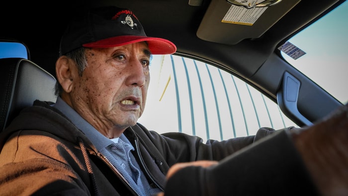 Un homme au volant de son véhicule.