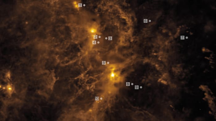 Discos de formação planetária em torno de estrelas jovens e sua localização na Nuvem de Órion, rica em gás.