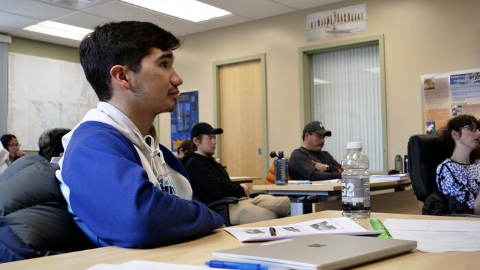 Un étudiant est assis derrière son bureau, dans une salle de classe du Collège de l'Arctique du Nunavut à Iqaluit, en octobre 2022.
