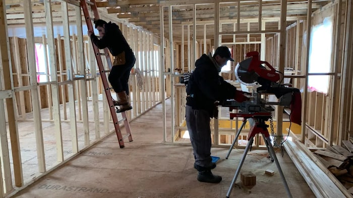 Odiss Fakhri and his father, Joseph Toma, spend long hours building the new home for the family.