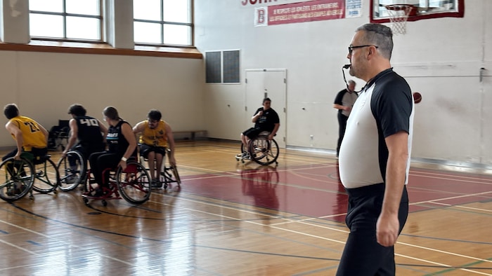 Jonathan Boily referees a wheelchair basketball game.