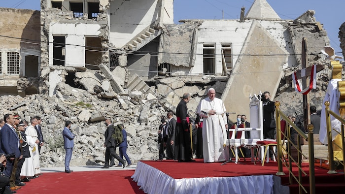 Le pape est debout au milieu de ruines.