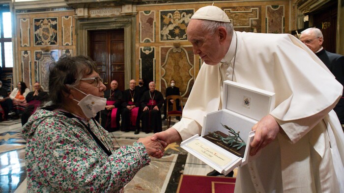 Pope Francis hands a gift to Rosemary Lundrigan of the Inuit delegation at the Vatican on April 1 2022.