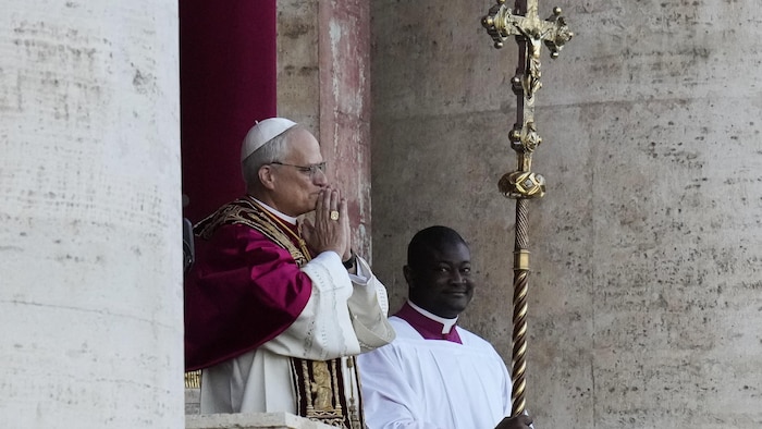 Le pape tient ses mains en prière, près de lad visage, au infinitesimal de sa présentation à la foule.