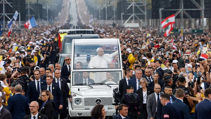 Le pape Léon salue la foule depuis la papamobile sur les Champs-Élysées, alors qu'il se rend à la place de la Concorde pour célébrer une messe en plein air, dans le cadre de son voyage apostolique de quatre jours en France, à Paris, le 26 septembre 2026.
