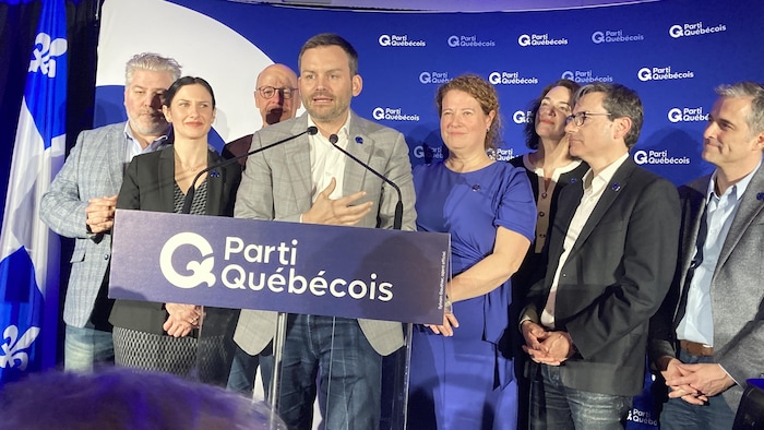 Des politiciens sont sur une scène.