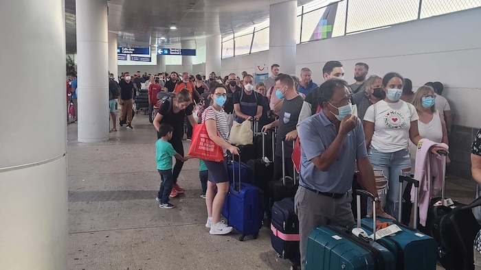 مسافرون على متن خطوط صن وينغ ينتظرون في مطار كانكون الدولي في المكسيك بسبب الرحلات الجوية المتأخرة أوالملغاة.