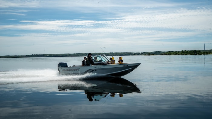 Un bateau voguant à vive allure, piloté par un agent de police et avec des enfants à son bord, file sur le lac Whitewater, à Azilda.