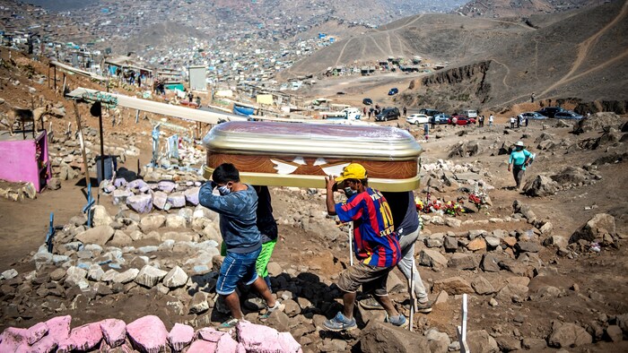 Unos hombres llevan un ataúd en las afueras de Lima, Perú.