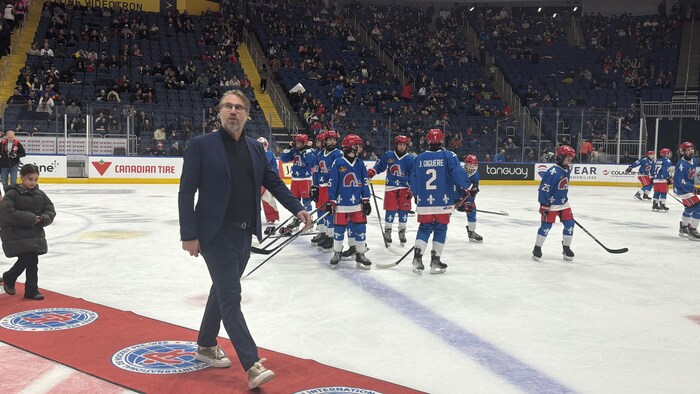 Peter Forsberg a marche sur un tapis rouge déroulé sur une patinoire.