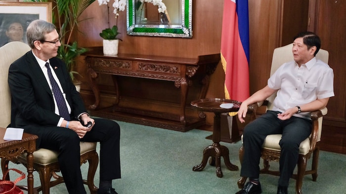 Nakaupo sina Peter MacArthur at Ferdinand Marcos Jr.