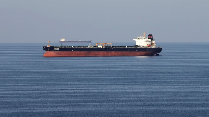 A large oil tanker sails on the water. weakened iranian regime, but not