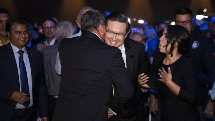 Le chef du Parti conservateur du Canada, Pierre Poilievre, serre dans ses bras son rival Scott Aitchison après l'annonce de sa victoire au scrutin pour la direction du parti, à Ottawa, le samedi 10 septembre 2022.