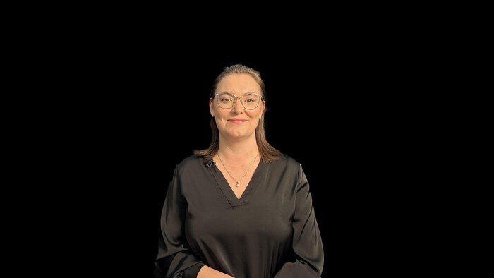 Photo of a young woman on a black background.