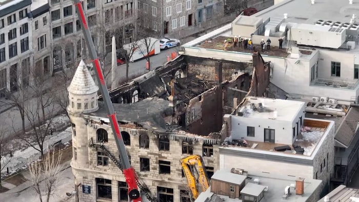 An aerial view of a heritage building destroyed by a fire.