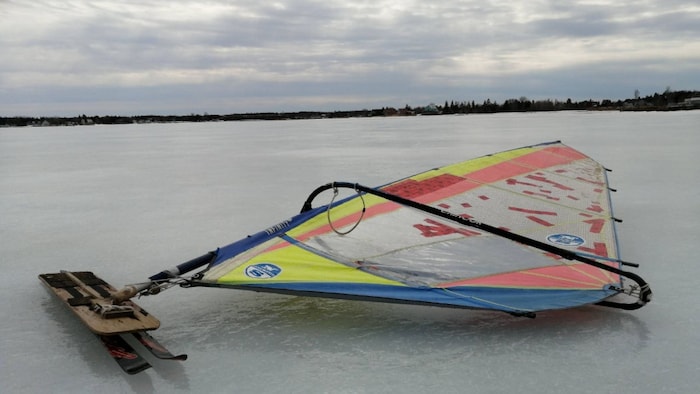 An ice windsurf board placed on ice. 